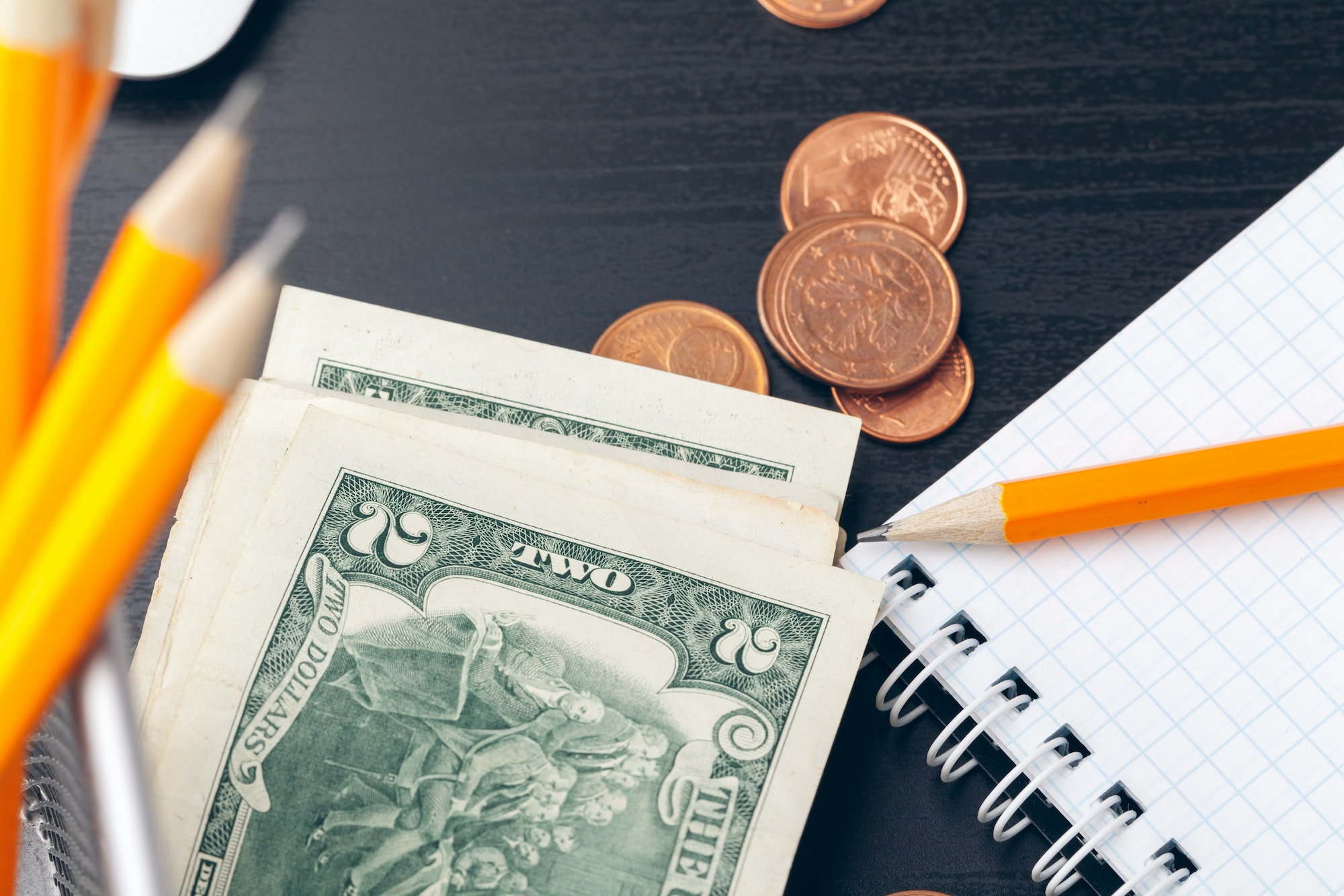 The close-up of accounting documents with money coins